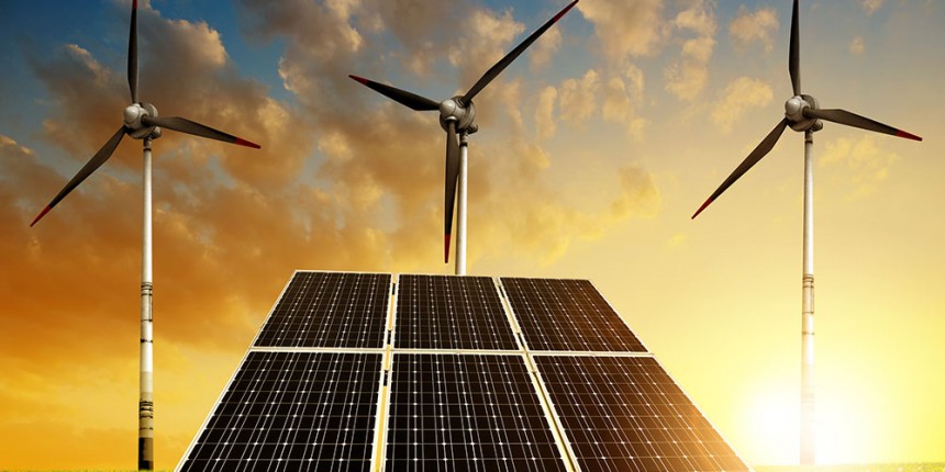 Solar panels with wind turbines in the setting sun