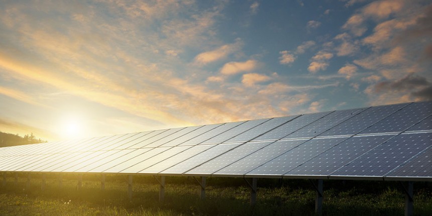 Solar panels under sky on sunset