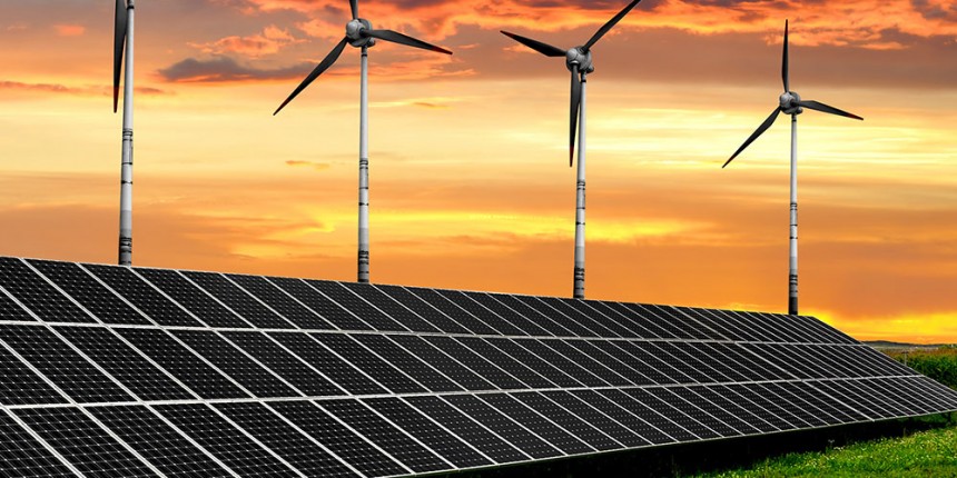 Solar energy panels with wind turbines in the setting sun